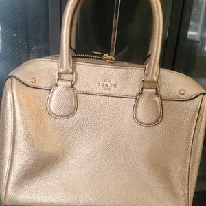 Small gold coach handbag